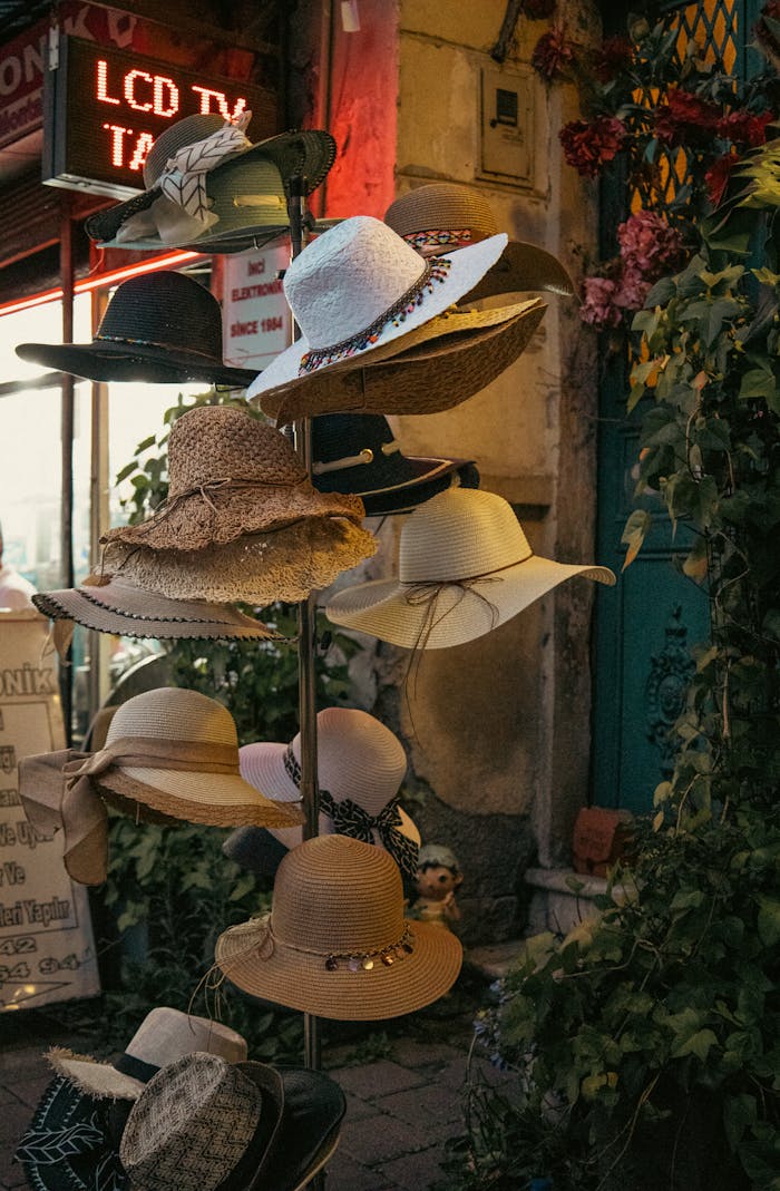 Explore a variety of stylish hats elegantly displayed in a quaint vintage market setting. Perfect for fashion enthusiasts.