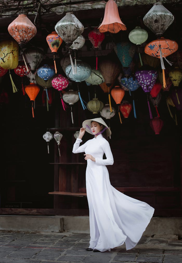 A stunning portrait of a Vietnamese woman in Ao Dai under colorful lanterns in Hội An.